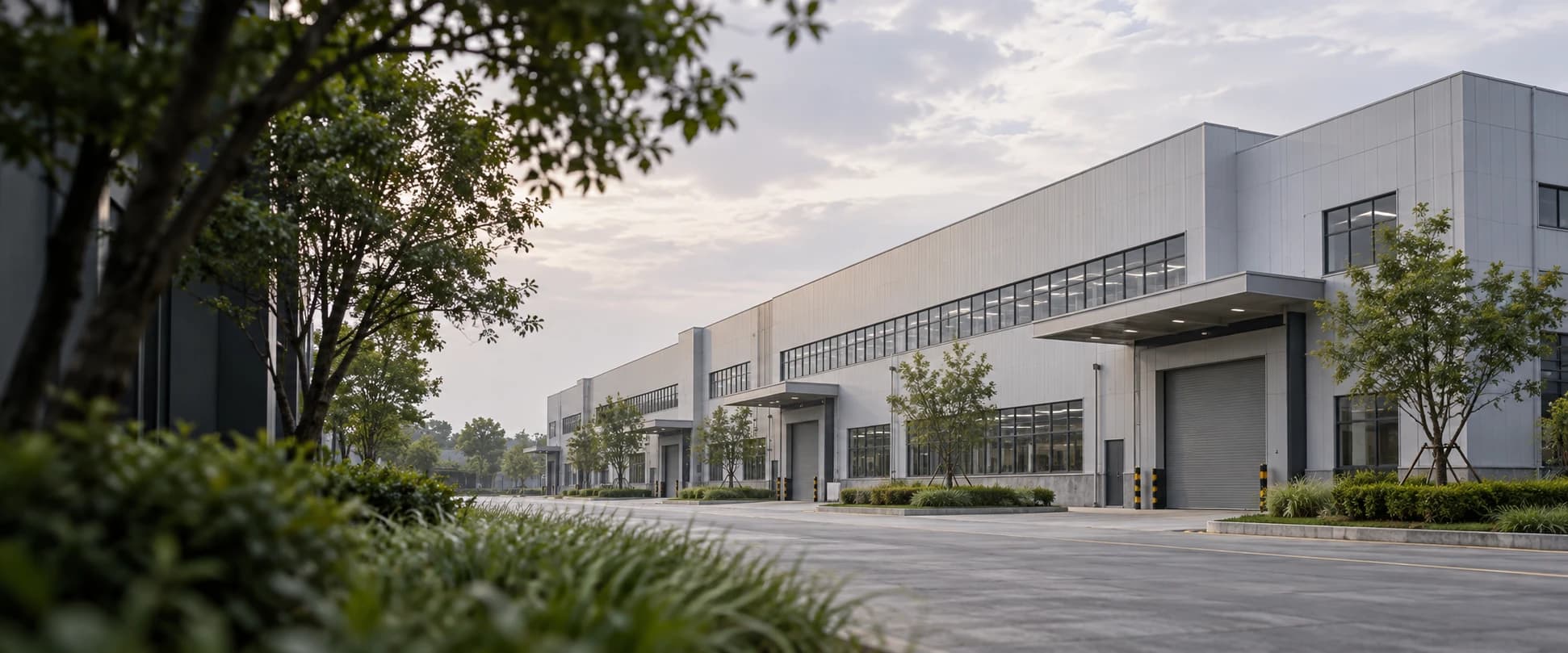 Contemporary industrial production buildings with landscaped access roads